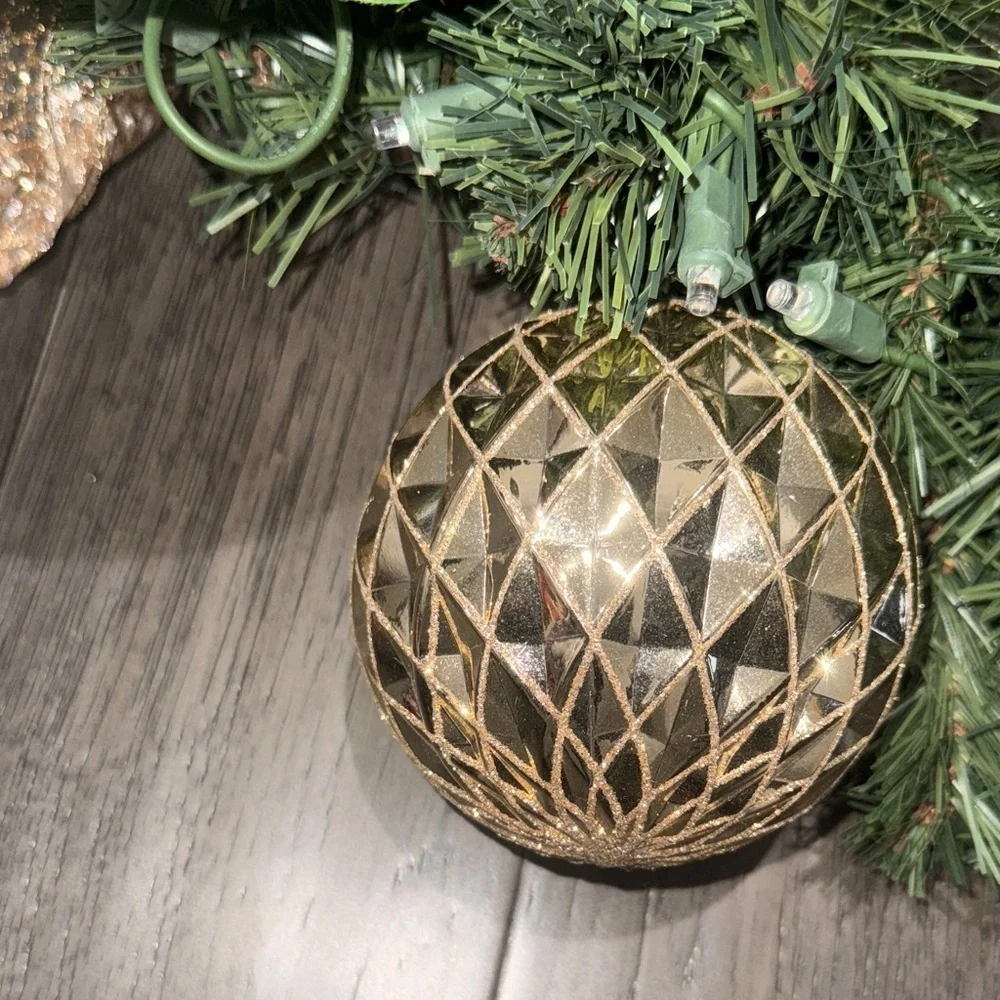 Festive Green Holiday Garland with Gold Accents and lights